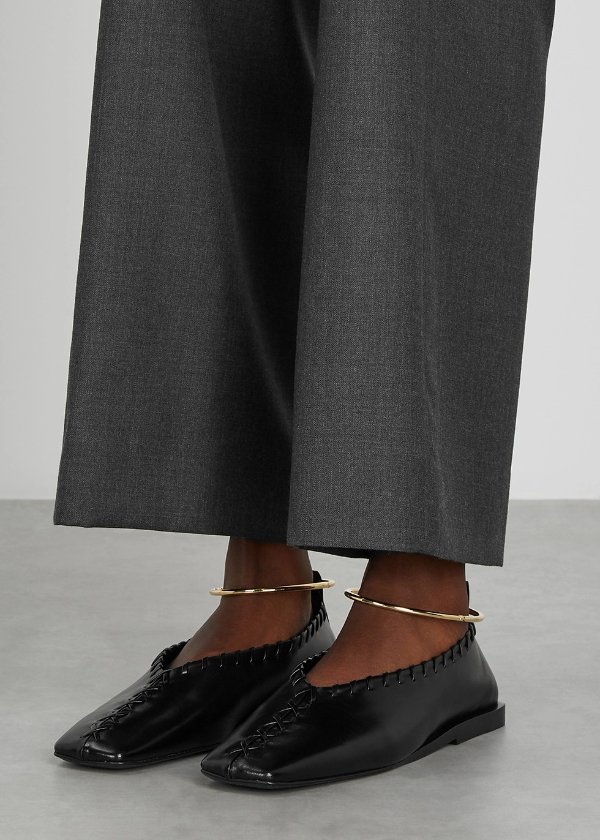 Black whipstitched leather flats