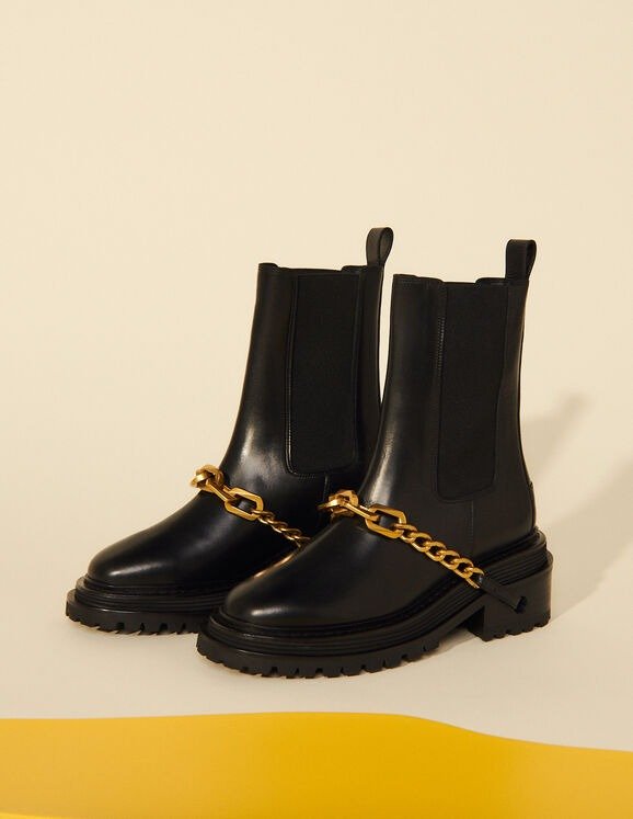 Ankle boots with notched sole and chain