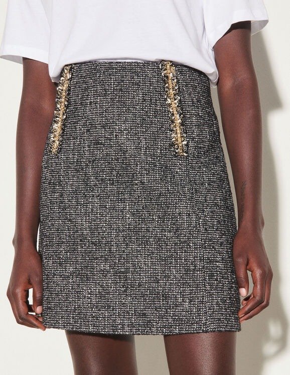 Short tweed skirt with chain trim