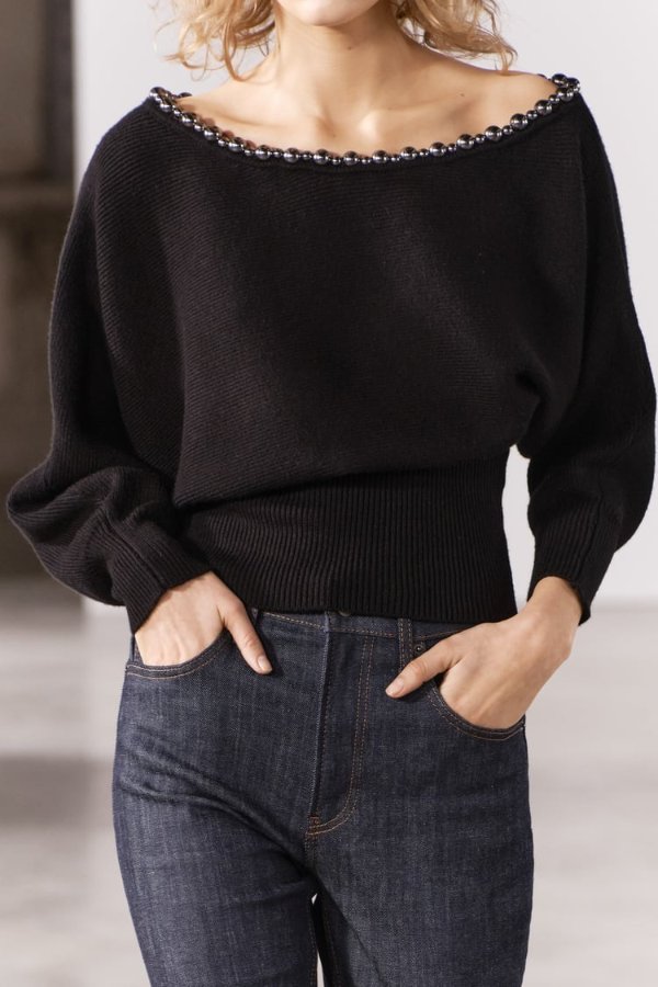 Sweater with wide collar with metal bead appliques. Long batwing sleeves.