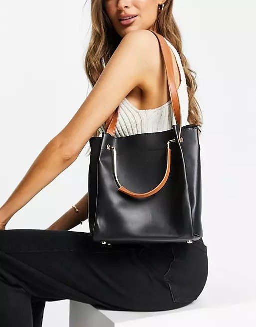 tote bag with tan handle and straps in black